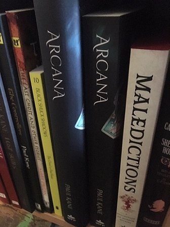 Hardback and softback copies of Arcana, by Paul Kane