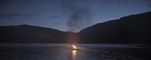 Boat burning in middle of lake