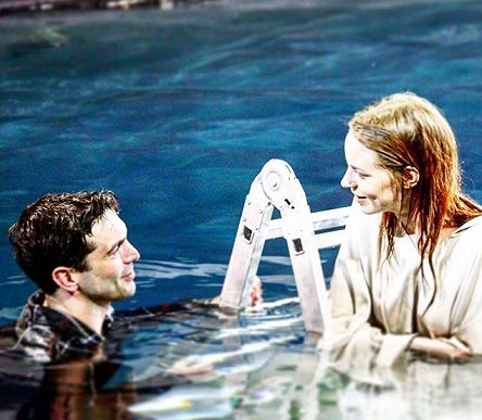 Man and woman smiling at each other in pool