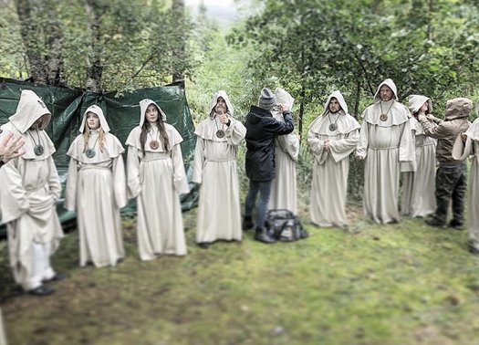 Behind the scenes shot- hooded figures with crew