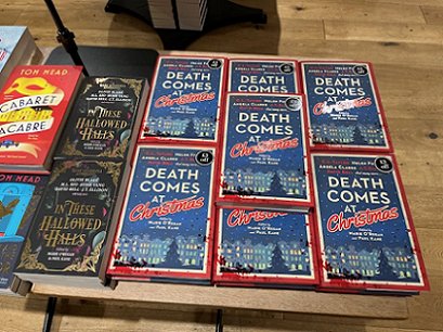 photograph of a shop display featuring copies of Death Comes at Christmas and In These Hallowed Halls, both edited by Marie O'Regan and Paul Kane