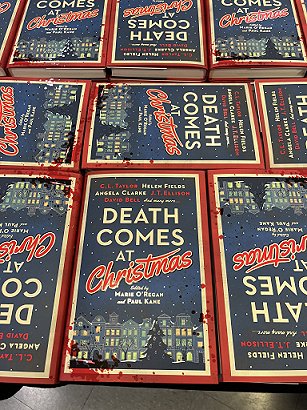 photograph showing several copies of Death Comes at Christmas, edited by Marie O'Regan and Paul Kane