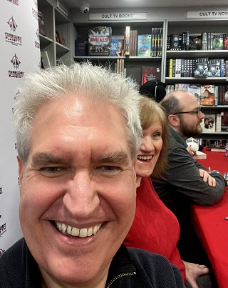 photograph of authors and editors at Forbidden Planet. Front to back: a smiling Paul Kane and Marie O'Regan, with Tom Mead behind them