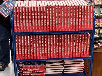 photograph of a trolley with three shelves, all filled with signed copies of Death Comes at Christmas, edited by Marie O'Regan and Paul Kane