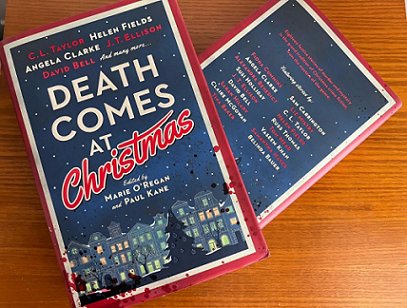 photograph showing two copies of Death Comes at Christmas, edited by Marie O'Regan and Paul Kane, on a wooden surface