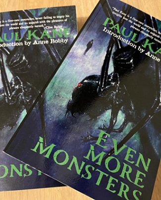 image showing two copies of the book Even More Monsters by Paul Kane lying on a wooden surface