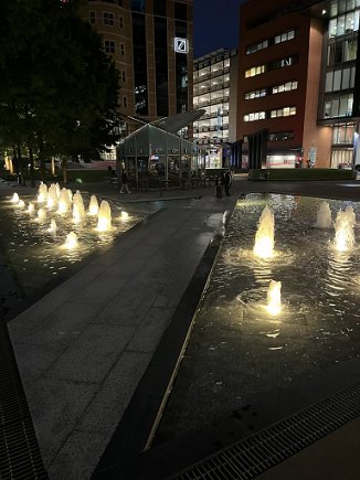Photograph of spotlit fountains at night