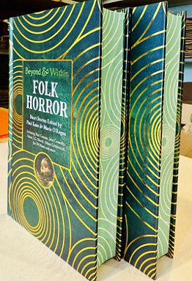 Display photograph of two copies of Beyond and Within Folk Horror, edited by Paul Kane and Marie O'Regan, standing on a cream surface