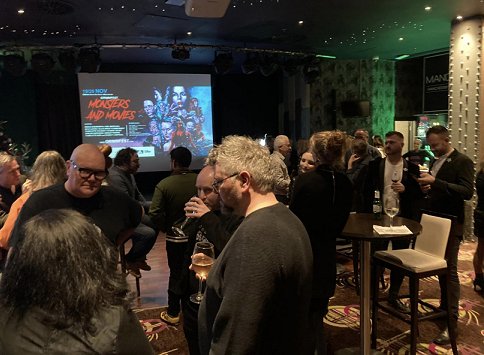 Image of people gathering at Monsters and Movies party