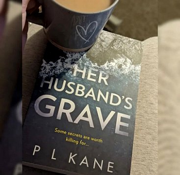 Book display: featuring cup of tea and Her Husband's Grave by P L Kane