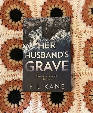 Copy of Her Husband's Grave by P L Kane on a crocheted blanket