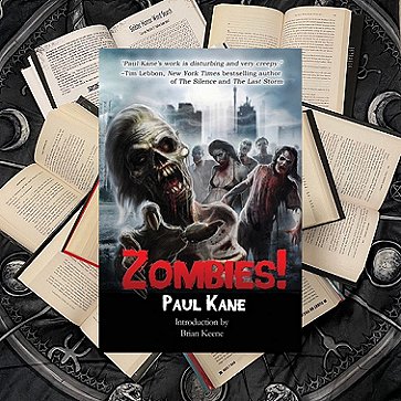 photograph showing the cover of Zombies! by Paul Kane, lying on top of a pile of open books