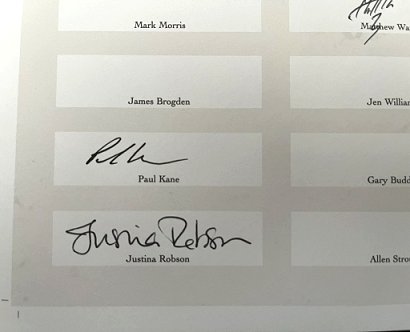 close-up photograph of a signing sheet for Heartwoood featuring signatures by Paul Kane and Justina Robson