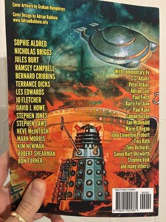 photograph showing a man's hand holding up a copy of the Daleks Special issue of Phantasmagoria magazine to show the back cover