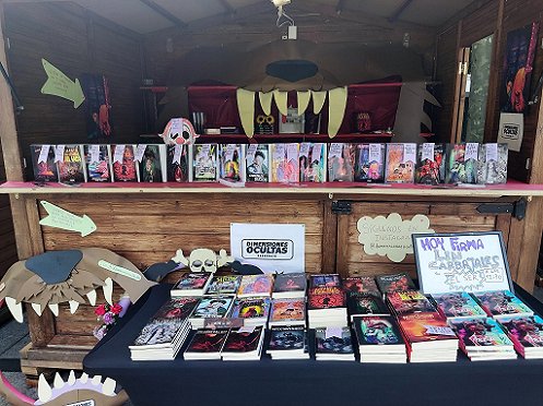 Book display at Celsius Festival, featuring the Spanish edition of Sherlock Holmes and the Servants of Hell by Paul Kane