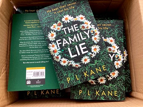 Image of a box of copies of The Family Lie by PL Kane