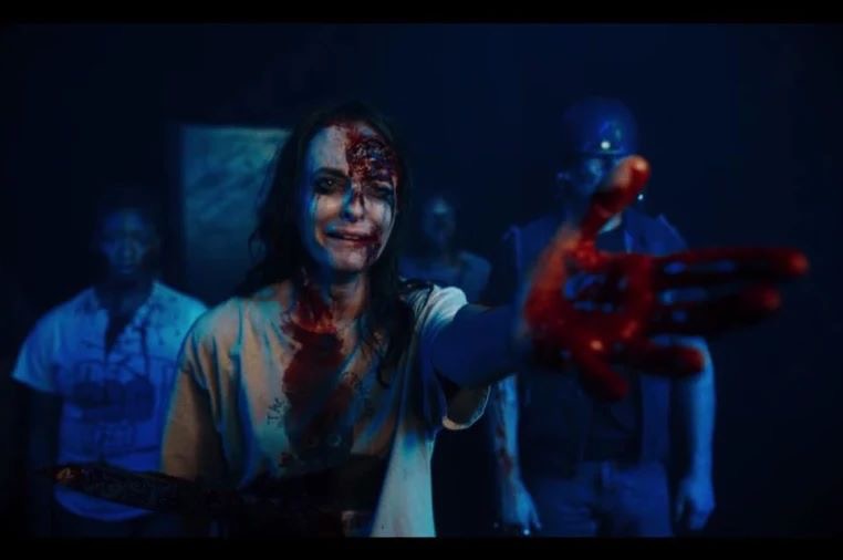 Still from The Torturer, injured woman pointing and crying