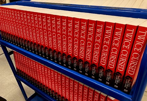 Trolley loaded with multiple copies of Twice Cursed, edited by Marie O'Regan and Paul Kane