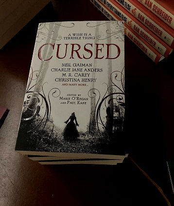 Display showing copies of Cursed, edited by Marie O'Regan and Paul Kane, for sale at the UK Ghost Story Festival