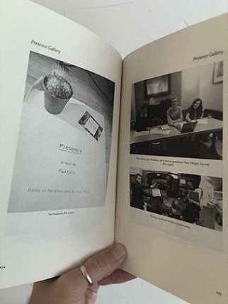 photograph showing a man's hand holding a copy of Short Sharp Shocks by Paul Kane, open to show illutstrations from Presence