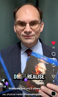 Photograph of Preston Fassell holding up a BluRay of The Torturer, written by Paul Kane