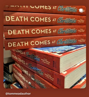 photograph of a stack of paperback copies of Death Comes at Christmas, edited by Marie O'Regan and Paul Kane - the books' spines are facing out